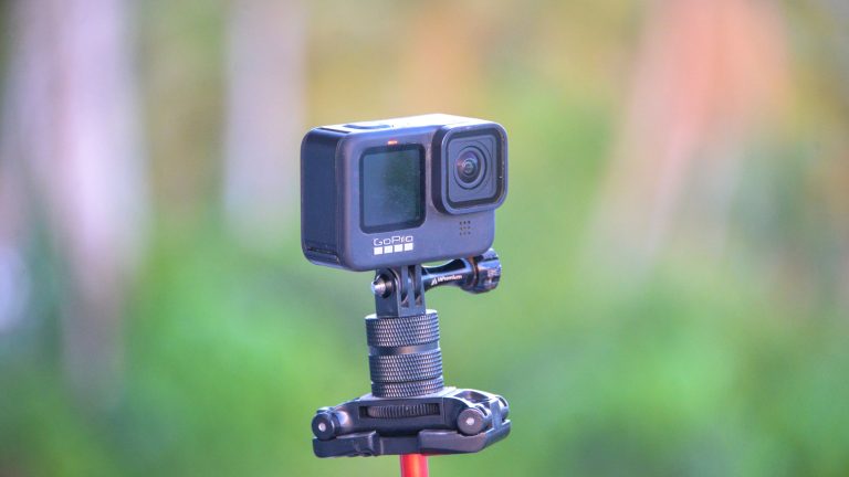 A current GoPro Hero action camera mounted on a tripod outdoors