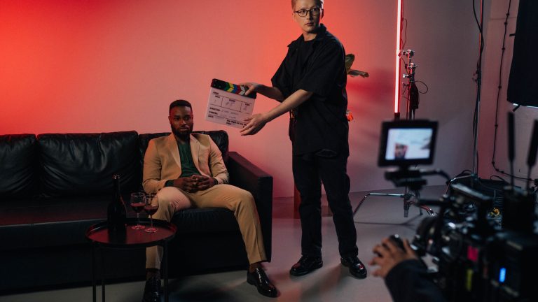 Film crew on set holding a clapperboard during a take