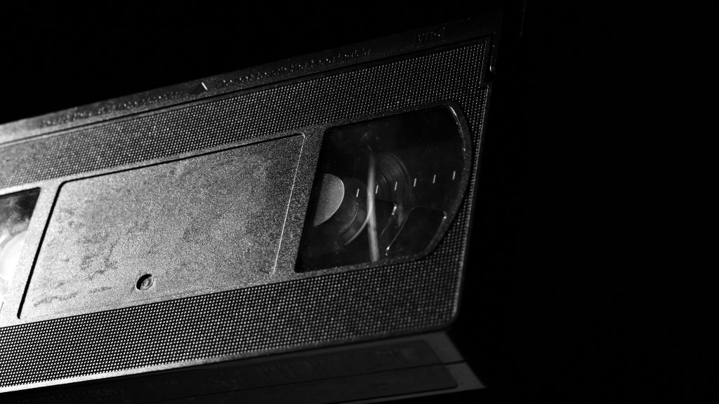Close-up of a VHS tape cassette, evoking found-footage horror