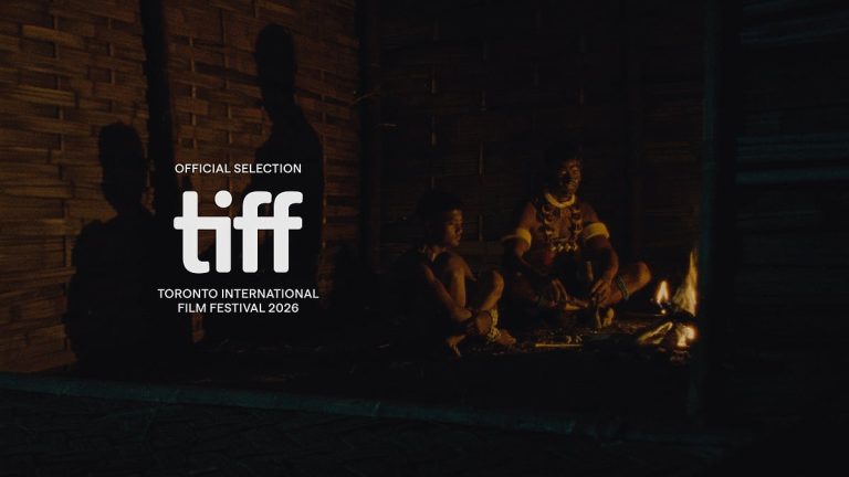 A firelit scene from Angh (2026), with the TIFF Official Selection laurel overlaid
