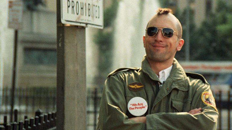 Robert De Niro as Travis Bickle in Taxi Driver (1976), the iconic mohawk-and-aviators look from Martin Scorsese and cinematographer Michael Chapman's New York. Copyright Columbia Pictures.