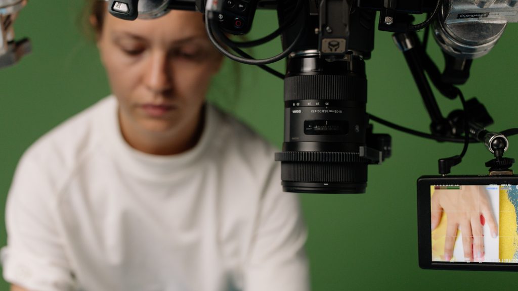 Camera lens and playback monitor on a green screen film set during a VFX shoot