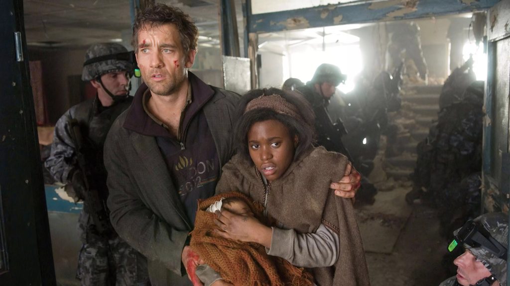 Theo (Clive Owen) and Kee flanked by soldiers in the war-torn refugee camp finale of Children of Men (2006)