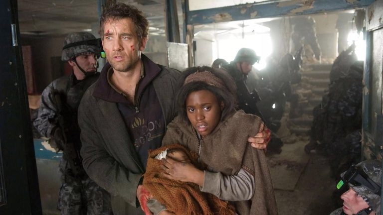 Theo (Clive Owen) and Kee flanked by soldiers in the war-torn refugee camp finale of Children of Men (2006)