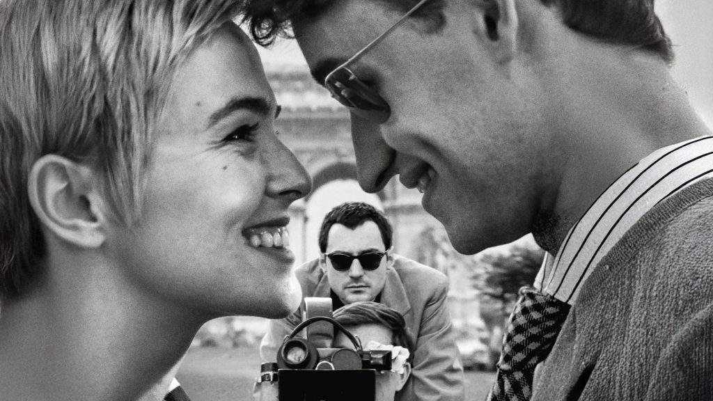 Guillaume Marbeck as Jean-Luc Godard filming Zoey Deutch as Jean Seberg and Aubry Dullin as Jean-Paul Belmondo on the set of Nouvelle Vague (2025), Netflix / ARP Productions