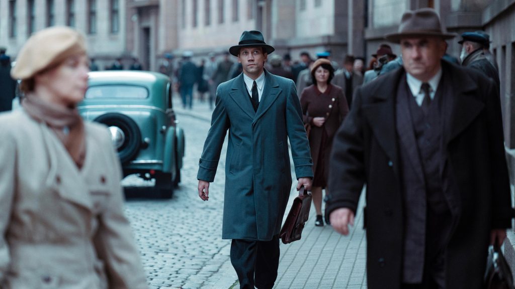 Two Prosecutors (2025), Barbaro Film / Arizona Productions / Studio Uljana Kim - prosecutor Alexander Kornyev walking a crowded 1930s Soviet street