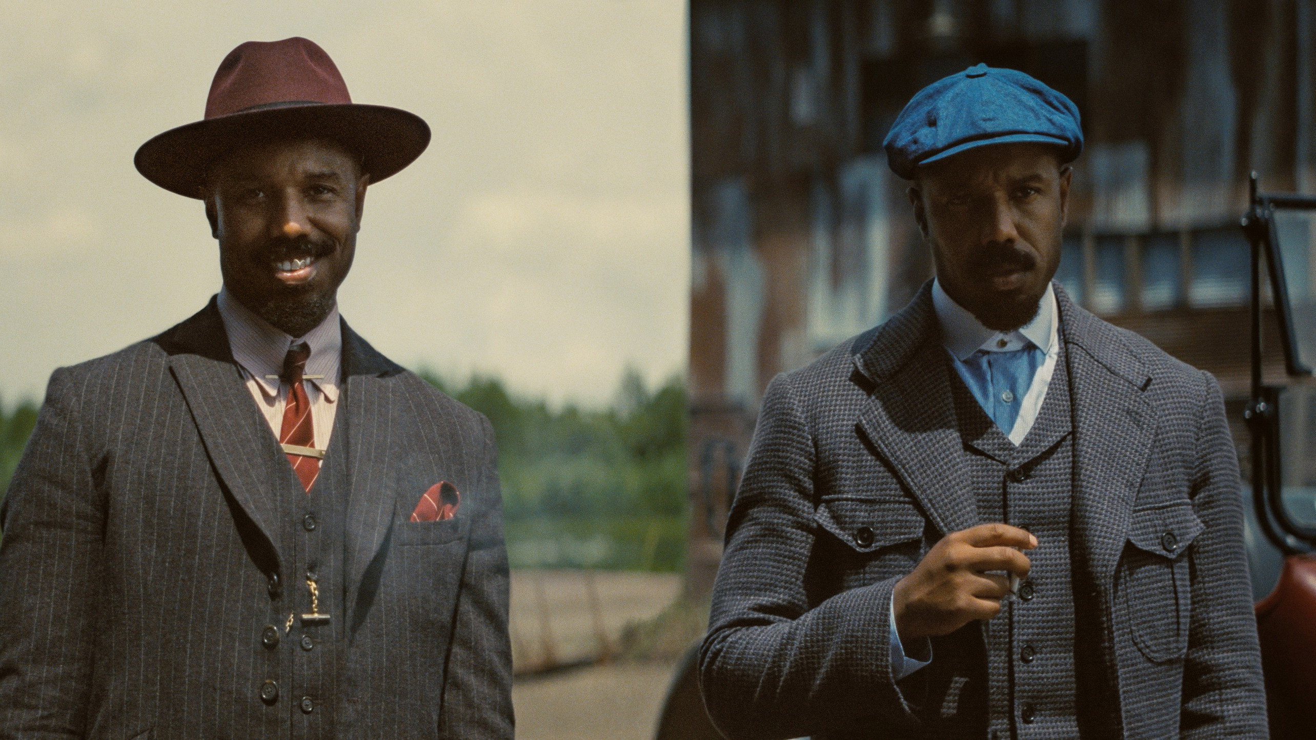 Sinners (2025) film still showing twin brothers Smoke and Stack, both played by Michael B. Jordan, dressed differently to help distinguish them